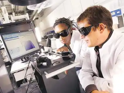 Bei Next Energy, dem EWE-Forschungszentrum, arbeiten die Doktoranden Kambulakwao Chakanga und Stefan Gei&szlig;end&ouml;rfer in modern ausgestatteten Laboren. Hier analysieren sie den Wirkungsgrad einer Solarzelle am Sonnensimulator.