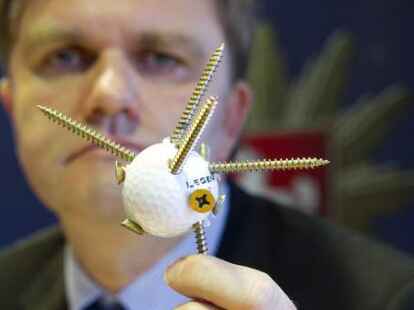 Niedersachsens Innenminister Uwe Sch&uuml;nemann (CDU) zeigt ein Wurfgeschoss, bestehend aus einem Golfball mit eingedrehten Schrauben, mit dem Polizisten angegriffen worden sind.