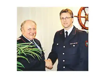 Kreisbrandmeister Werner Zirk gratuliert Dieter Schnittjer.