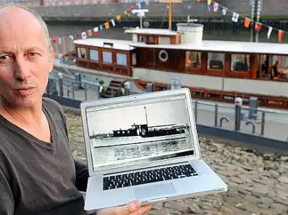 Eigner Georg Papp zeigt auf seinem Laptop vor seiner restaurierten Jacht &bdquo;Nedeva