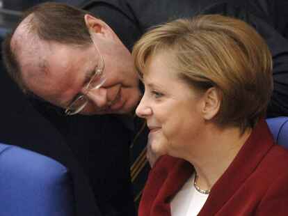 Bundeskanzlerin Angela Merkel (CDU) unterhält sich im Jahr 2006 im Bundestag in Berlin mit dem damaligen Bundesfinanzminister Peer Steinbrück (SPD). Am Sonntag begegnen sich die beiden Politiker im TV-Duell.