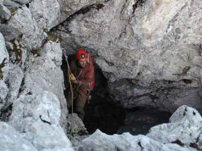 Ein H&ouml;hlenretter seilt sich in die H&ouml;hle ab.