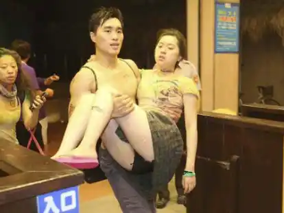 Ein Mann tr&auml;gt eines der Opfer von der Ungl&uuml;cksstelle weg.