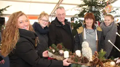 Gl&auml;nzende Aussicht: Britta Prockl (links) aus Hatterw&uuml;sting verkauft an die Familie Herrmann aus Hude eine aufwendig hergestelltes Tischgesteck.
