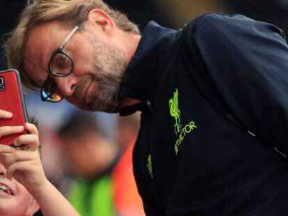 Soviel Zeit muss sein: LFC-Trainer J&uuml;rgen Klopp posiert f&uuml;r ein Foto mit einem jungen Fan.