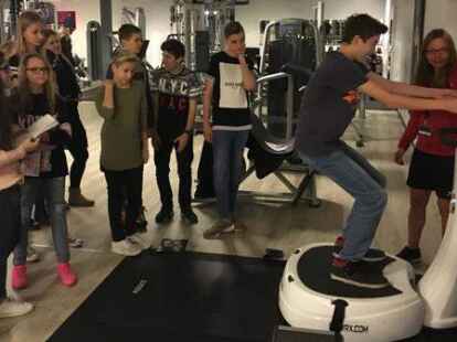 Die Klasse 8.5 der IGS Friesland Nord war am 6. Dezember bei Viva Fitness in Schortens und hat sich von den Fitnesstrainern Janosch Brunken und Ina Heyen die verschiedenen Ger&auml;te erkl&auml;ren lassen. Dabei durften die 26 Sch&uuml;ler viele &Uuml;bungen selbst ausprobieren.