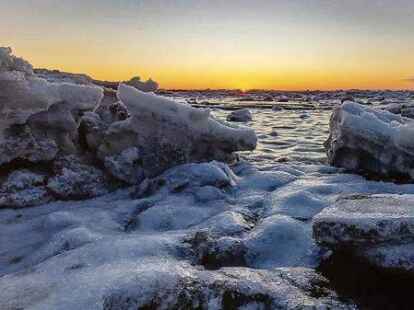 Eisschollen bei Sonnenaufgang am S&uuml;dstrand.