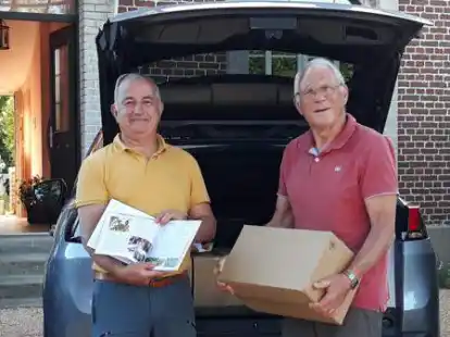 Vor dem Haus der Familie Prudhomme in Berneval freuten sich Vincent Prudhomme (links) und Christian Belletre &uuml;ber die 200 Kochb&uuml;cher.