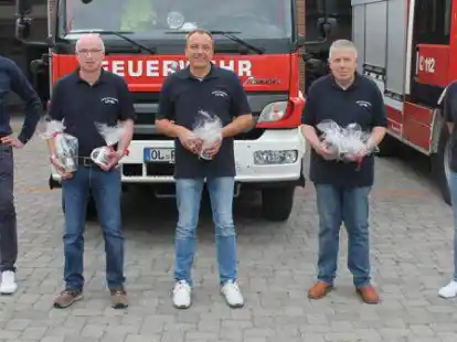 B&uuml;rgermeister Christoph Reents (links) und Ortsbrandmeister Tobias Hollmann (rechts) bei der Verabschiedung von Heiko Poppe (von links), Lars Gramberg und Heino Martens aus dem Ortskommando.
