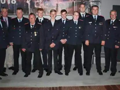 Ortsbrandmeister Thomas Heuermann (von rechts) und der stellvertretende Kreisbrandmeister Frank Hattendorf sowie (von links) der stellvertretende Ortsbrandmeister Christoph Windhusen und Samtgemeindeb&uuml;rgermeister Herwig W&ouml;bse mit den Geehrten und Bef&ouml;rderten der Feuerwehr Harpstedt: Rolf Ranke, Wolfgang M&uuml;ller, Dennis K&ouml;nig, Lukas Landgraf, Marlon Landgraf, Jana Siemers, Marius Kr&auml;kel und Nico Sparkuhl.