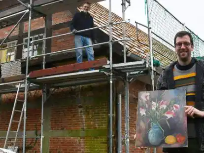 Auf dem Tabkenhof wird der Spieker saniert: Verwalter Fabian Ebelt (vorn) mit dem gefundenen Bild, auf dem Ger&uuml;st steht Hofmitarbeiter Uwe Peper.