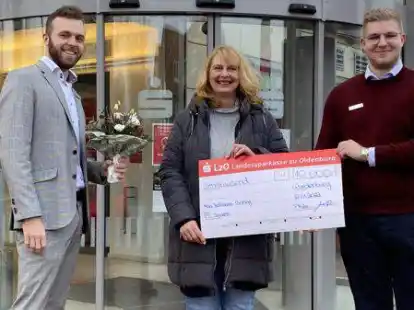 Anja Hollmann-Boning aus der Gemeinde Wardenburg gewinnt bei der LzO-Lotterie Sparen + Gewinnen 10 000 Euro. Die Kundenbetreuer Jonas Hanken (links) und Philipp M&uuml;ller &uuml;berreichen den symbolischen Scheck.