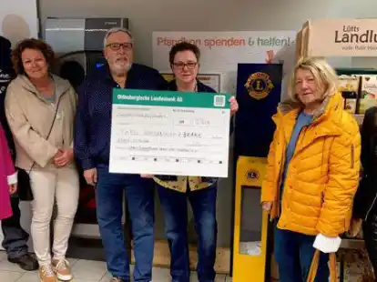 (Von links) Imke Janssen, Jens Meerpohl, Sandra Renken, Meinhard Thomolske, Renate Detje, Hanne Thomolske und S&uuml;ntka Jan&szlig;en bei der Scheck&uuml;bergabe der gesammelten Summe. Neben ihnen die Pfandbon-Spendebox.