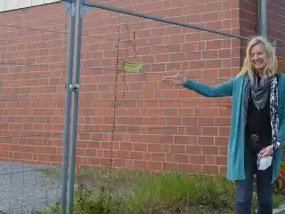 Hier hing die Friedensbotschaft  der Grundschule D&uuml;rerstra&szlig;e: Schulleiterin Insa Nessen vor dem Bauzaun, an dem das Banner bis zu den Osterferien befestigt war.