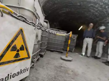 Vor Containern mit radioaktiver Lauge h&auml;ngt ein Warnschild mit der Aufschrift &bdquo;Radioaktiv&ldquo;.