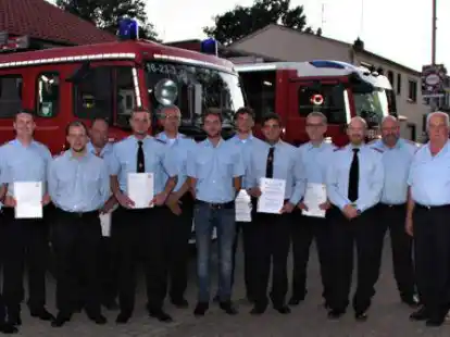 Urkunden f&uuml;r die Bef&ouml;rderten: Vize-Ortswehrleiter Dirk Junkermann (v. L.), Martin Steigerwald, Sven Ole Alisch, Daniel Burhop, Noah Andersson, Volker L&uuml;bben, Leon Cl&ouml;ren, Niklas P&ouml;hlker, Benjamin R&uuml;ffer, Michael B&ouml;rsig, Alexander Geisler, Mathias Sielmann, Gemeindebrandmeister Heiko Bruns und Tobias Habben, Vertreter des B&uuml;rgermeisters.