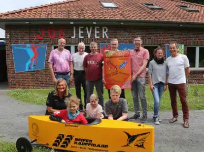 Startbereit f&uuml;rs Seifenkistenrennen Jever 2022: Tom (vorn von links), Lea und Max freuen sich schon sehr darauf. Viele Erwachsene helfen mit, damit der Tag gelingt.