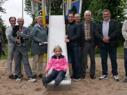 Hat den Spielplatz an der H&auml;ndelstra&szlig;e in Edewecht schon mal eingeweiht: Die sechsj&auml;hrige Elvira Stangenberg (Mitte) freut sich sehr &uuml;ber das neue Angebot. Bei der offiziellen Er&ouml;ffnung waren vor Ort (von links): Wolfgang Schramm, Ralf Gauger, Carsten Brucks, Petra Knetemann,  J&ouml;rg Brun&szlig;en, Henning Diers, Hans Fittje, Karsten Lanz und Rolf Torkel.