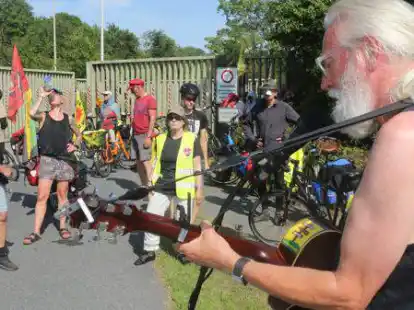 Der Liedermacher Gerd Schinkel sang vor dem Werktor des Kernkraftwerks Unterweser einen Anti-Atom-Song.