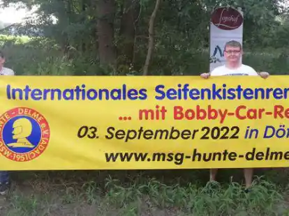 H&auml;ngen das Banner auf f&uuml;r das Seifenkistenrennen: Herwig (links) und Pierre Henning