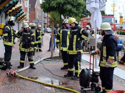 R&uuml;ckten dem brennenden Trockner unter den wachsamen Augen der Besucher zu Leibe: die Kameraden mehrerer Feuerwehren. Bild: Pries
