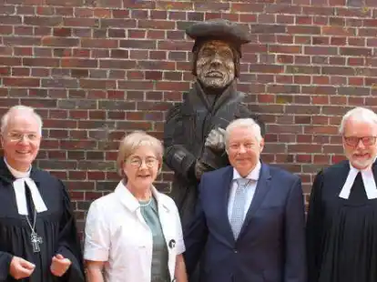 Regionalbischof Dr. Detlef Klahr (links) und Pastor Kurt Booms (rechts) bedankten sich bei Weert Smid und dessen Frau Gretel f&uuml;r 50 Jahre Organistendienst, hier vor dem Luther-Denkmal in Weene.