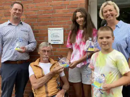 Sonja (15, Mitte) und L&ouml;scha (9, 2. v. r) bedankten sich bei Ovelg&ouml;nnes B&uuml;rgermeister Sascha Stolorz (links), Herge Koopann vom Verein &bdquo;von Mensch zu Mensch&ldquo; (2. v. l.) und Ulrike Mayer vom Familien- und Kinderserviceb&uuml;ro (rechts) mit selbstgemachten Kerzen in den Farben ihres Heimatlandes.