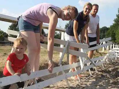 Alle helfen beim RFV Edewecht-Portsloge mit:  Sophie und Ann-Christin Ristow (von links), Bettina Bonsack und Kai Mitwollen bauen das Dressurviereck mit auf.