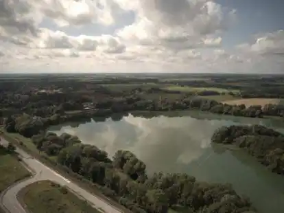 Blick auf den Sander See mit der davor verlaufenden K294 und der Anlage Gut Altmarienhausen (rechter Bildrand) mit Wohnmobilstellplatz, Paddel- und Pedalstation und K&uuml;steum.