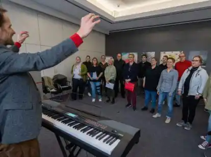 Gute Stimmung: Chorleiter Erwan Tacher mit den S&auml;ngerinnen und S&auml;ngern am Montagmittag im Probenraum.