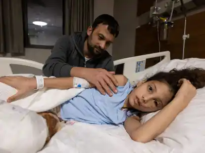 Z&auml;rtlich streicht Serkan Agri seiner Tochter Saadet im Krankenhaus von Adana &uuml;ber den Arm.