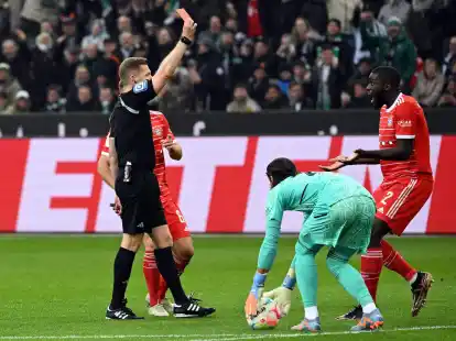 Schiedsrichter Tobias Welz zeigt Bayerns Dayot Upamecano (r) die rote Karte.