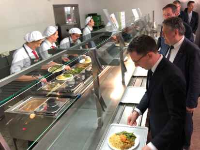 &bdquo;Niedersachsen-Men&uuml;&ldquo; trifft den Geschmack des Ministers: Falko Mohrs (vorn) an der Essensausgabe der Mensa des Studentenwerks Hannover. Dahinter Staatssekret&auml;r Prof. Joachim Schachtner und die Gesch&auml;ftsf&uuml;hrer der Studentenwerke.