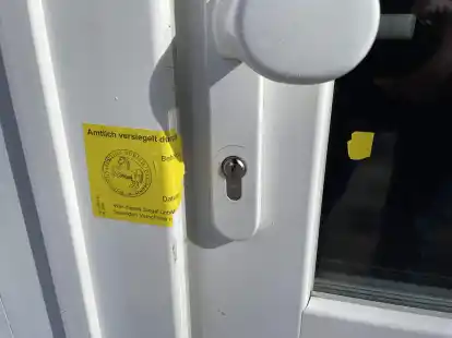 Ein gebrochenes Polizeisiegel an der Eingangst&uuml;r des Hauses, in dessen Keller es am Donnerstag brannte, ist noch vorhanden.