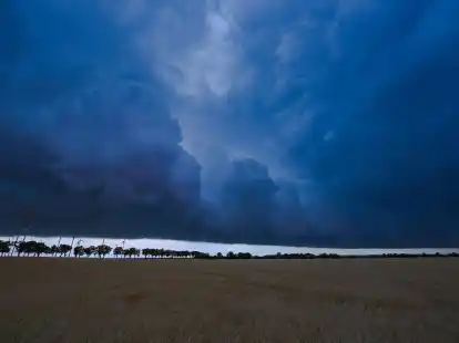 Eine Gewitterzelle zieht mit dunklen Regenwolken &uuml;ber die brandenburgische Landschaft. Der Deutsche Wetterdienst hat die Klima-Bilanz f&uuml;r das Jahr 2022 vorgestellt.
