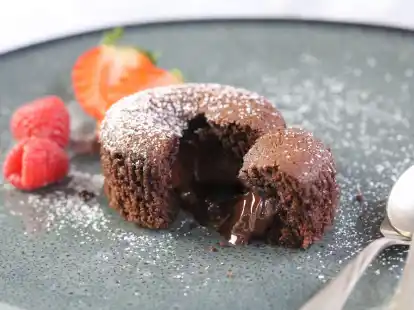 Fl&uuml;ssige Schokolade flie&szlig;t aus dem Muffin.