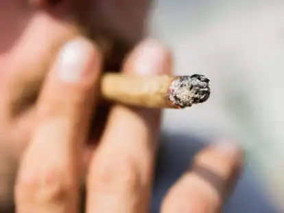 Ein Mann raucht einen Joint. Mit der geplanten Cannabis-Legalisierung sollen auch die Regeln f&uuml;r Cannabis-Konsumenten im Stra&szlig;enverkehr auf den Pr&uuml;fstand.