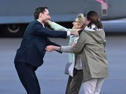 Olivier Vandecasteele (l) trifft seine Familie bei der Ankunft auf dem Milit&auml;rflughafen Melsbroek.