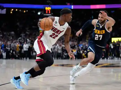 Miami Heat-Forward Jimmy Butler (l) bewegt den Ball, w&auml;hrend er von Denver Nuggets-Guard Jamal Murray verteidigt wird.