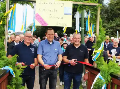 Durchschnitten das Band und er&ouml;ffnetnen damit an der Heeren-Wehren-Br&uuml;cke in Apen die neue historische Fahrradroute: Frank Zahn (von links), B&uuml;rgermeister Matthias Huber und Torsten Taute.