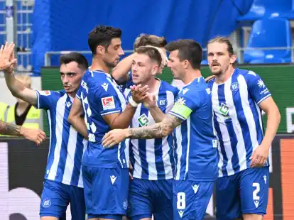 Die Karlsruher bejubeln den Treffer zum 1:0 durch Leon Jensen (M).