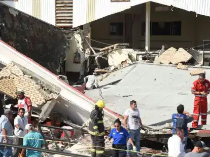 Rettungskr&auml;fte suchen inmitten von Tr&uuml;mmern nach &Uuml;berlebenden.