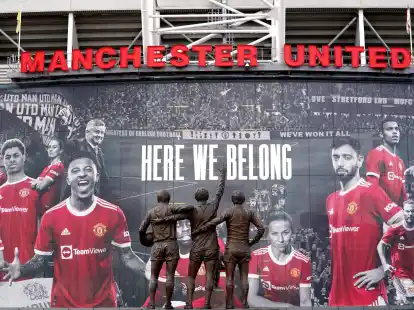 Vor dem Stadion Old Trafford stehen Statuen der ehemaligen Manchester-United-Spieler George Best, Denis Law und Sir Bobby Charlton.