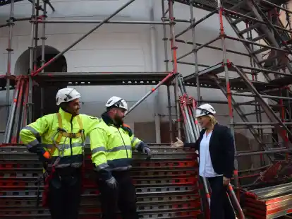F&uuml;r die Arbeiten, die die R&uuml;ckkehr der Wetterfahne auf den jeverschen Schlossturm vorbereiten, wird zurzeit der Turm komplett einger&uuml;stet. Museumsleiterin Prof. Dr. Antje Sander hier im Gespr&auml;ch mit den Ger&uuml;stbauern der Wilhelmshavener Firma Nietiedt, Jeton Remziu (links) und Alban Qenani.
