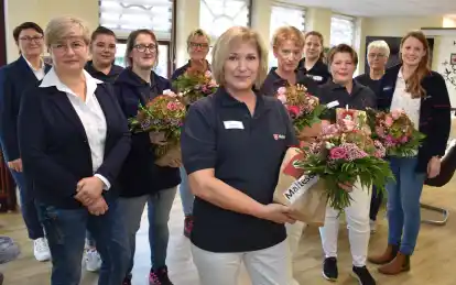 Blumen und Geschenke der Malteser gab es vor der ersten Dienstbesprechung auch f&uuml;r die Pflegekr&auml;fte (von links): Uljana Kalinowski und Irina Scheifel von der Pflegedienstleitung des Ambulanten Pflegedienstes der Malteser Wesermarsch, die Pflegekr&auml;fte Larissa Bohlen, Jessica Hahner, Helga Prophet, Heike Hatscher, Meike Bolting, Vanessa Reimers, Valentina Spiekermann und Heikea Bruns sowie die Dienstellenleiterin Netzwerk Pflege der Malteser im Oldenburger Land, Pia Kaling.
