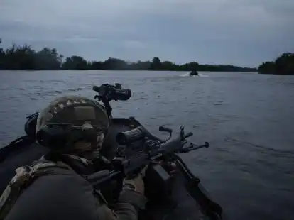 Ukrainische Soldaten fahren mit einem Boot auf dem Fluss Dnipro an der Frontlinie in der N&auml;he von Cherson.