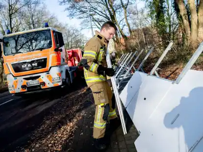 Einsatzkr&auml;fte der Feuerwehr bauen ein mobiles Deichsystem ab.
