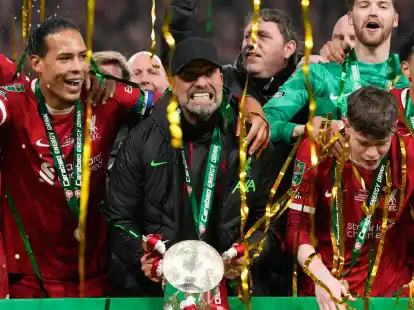 J&uuml;rgen Klopp (M) jubelt mit dem Pokal.