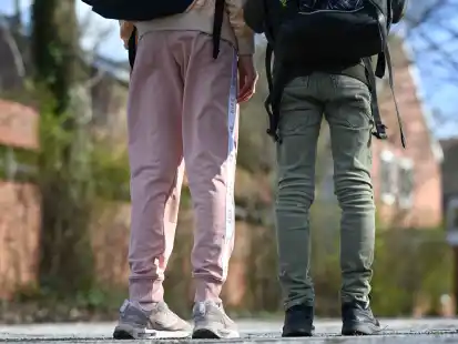 Eine Schülerin in Jogginghose eine in Jeans: Schlabber-Outfits sind nicht jedermanns Sache – müssen sie aber auch nicht.