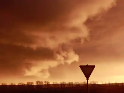Eine Schlechtwetterfront zieht bei tief stehender Sonne &uuml;ber den Harz hinweg.